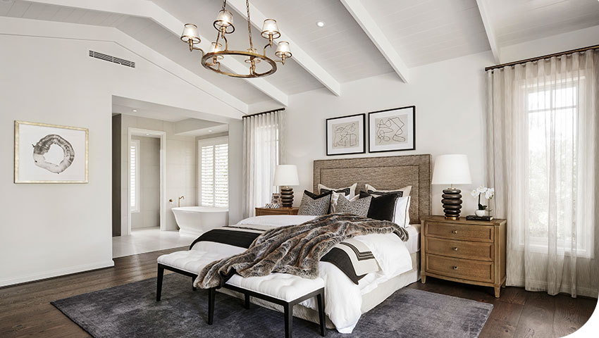 Interior view of a modern master bedroom featuring a discreet Fujitsu ducted heat pump bulkhead vent installed flush with the ceiling.