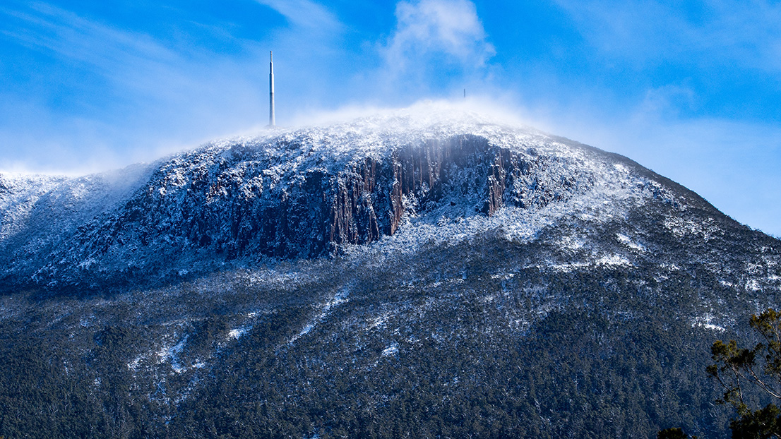 A cold mount wellington in Hobart Tasmania with snow on it suggesting its time to heat your house.